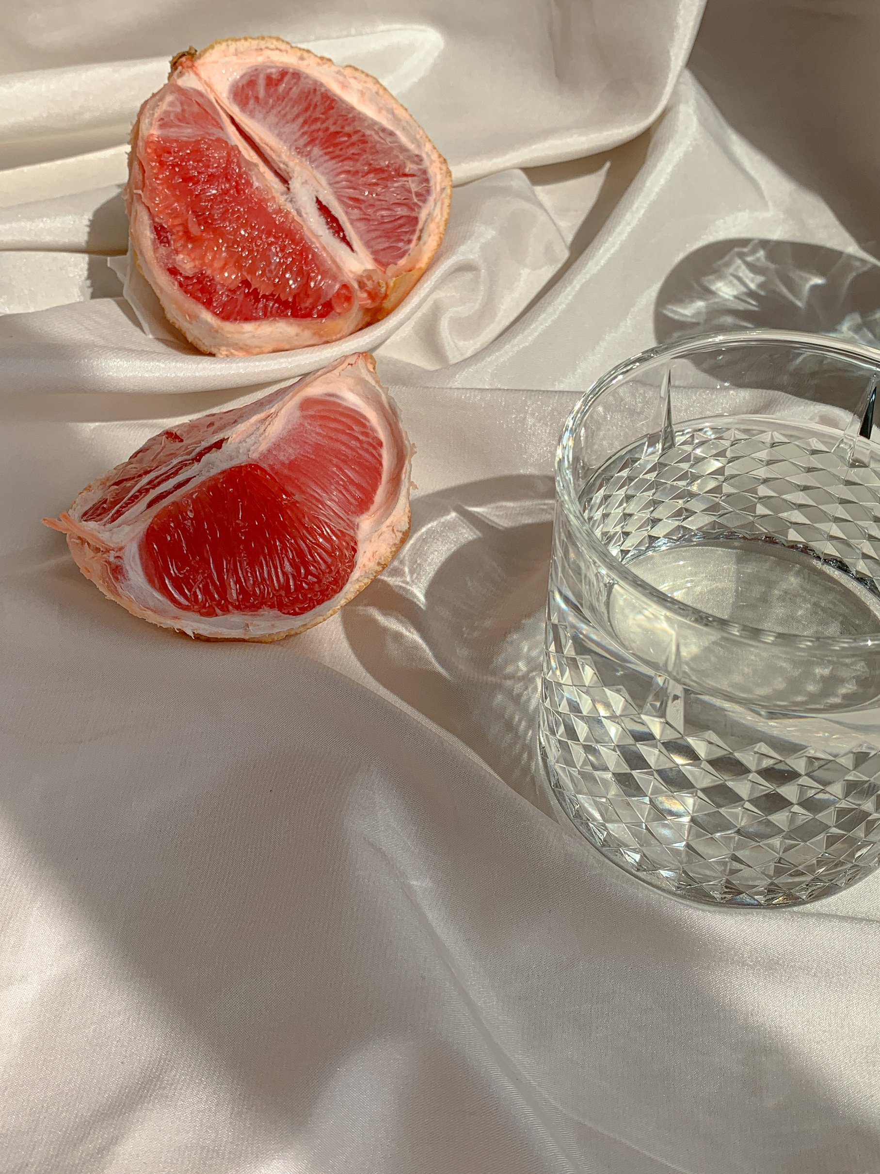 Grapefruit near Glass of Water