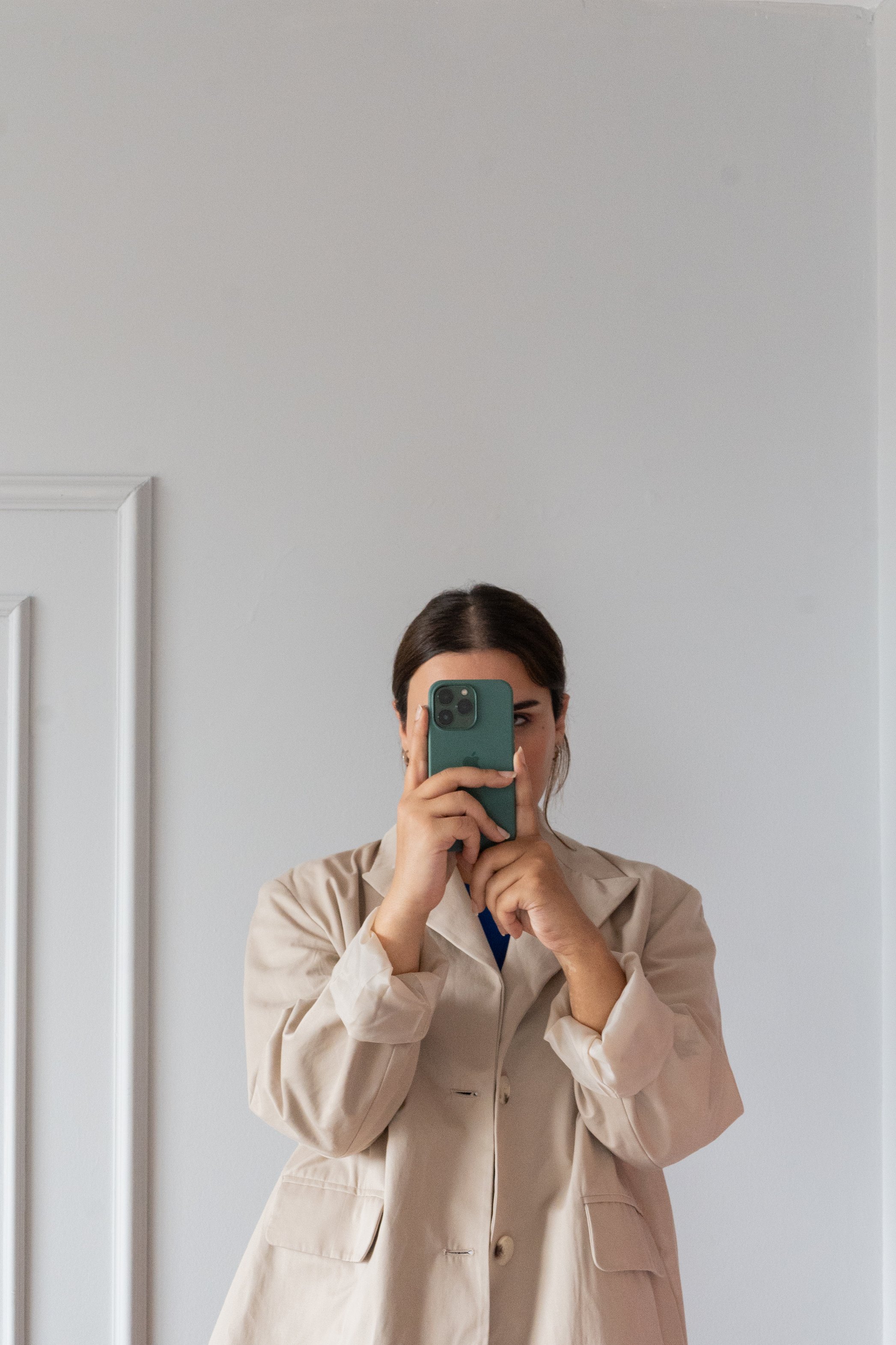 Woman in Brown Coat Taking Selfie