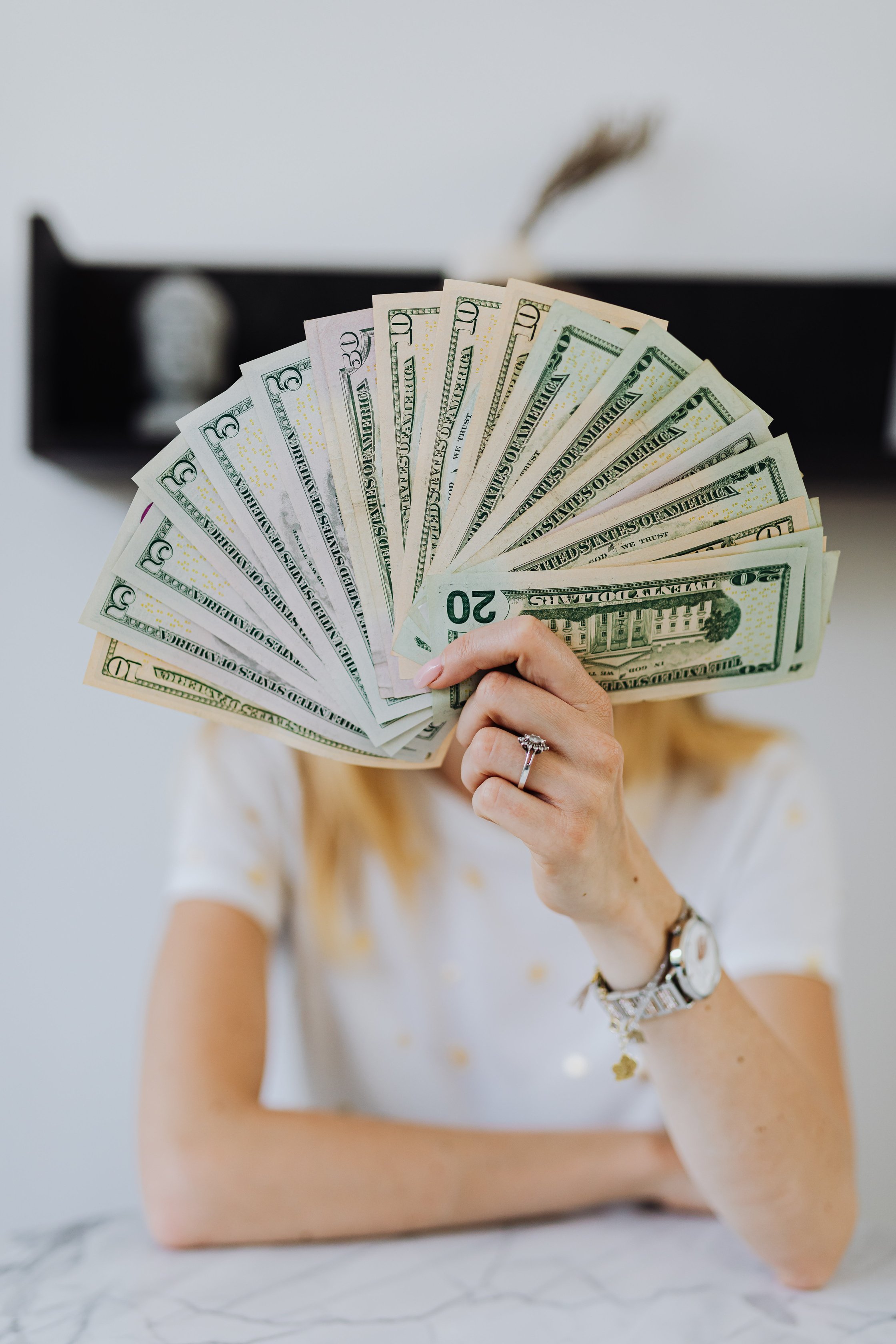 Person Holding Fan of Us Dollar Bills